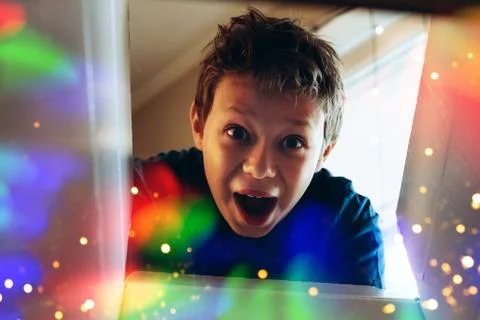 Happy boy opening present Stock Photos