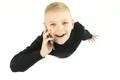 The happy boy phone on the white background. View from above Photo