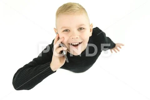 The happy boy phone on the white background. View from above Stock Photos