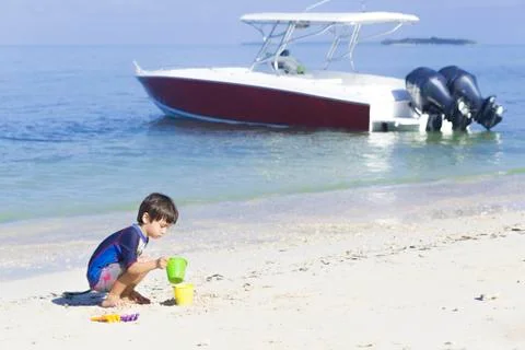 Happy boy playing on the beach Stock Photos