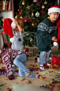 Happy Boy is playing in front of a decorated Christmas tree Stock Photos