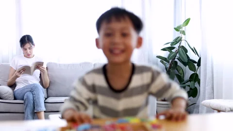 Happy boy playing hide and seek with the camera, little son peeks out from .. Vídeo Stock 244042368
