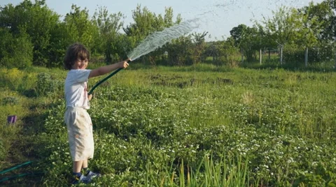 Happy boy playing hosing on backyard Stock-Footage 50503753