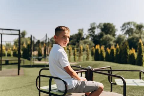 Happy Boy Playing on Modern Playground Stock Photos