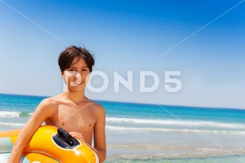 Happy boy ready for summer activities at seaside Stock Photos