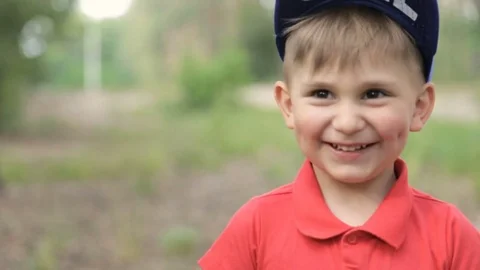 Happy boy in a red t-shirt in the forest Stock Footage