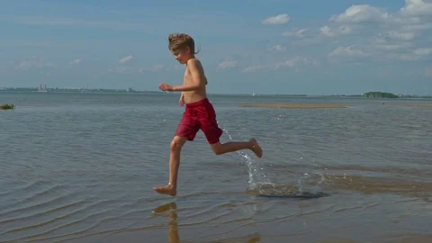 Happy boy running at beach Stock Footage 97987414