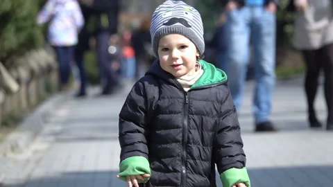 Happy boy running on the pathway, slow motion shot at 240fps Stock Footage 93240432