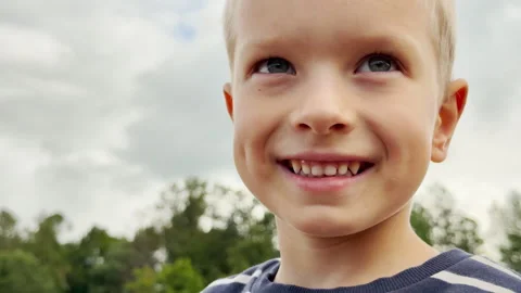 A happy boy runs joyfully along the sandy shore. Video stock 344986943