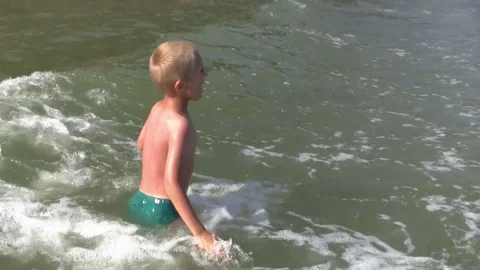 Happy boy in the sea waves Stock Footage 78802987
