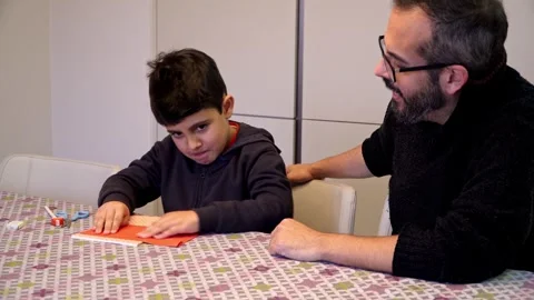 Happy boy sealing envelope with Christmas wish list Vídeo Stock 345253396