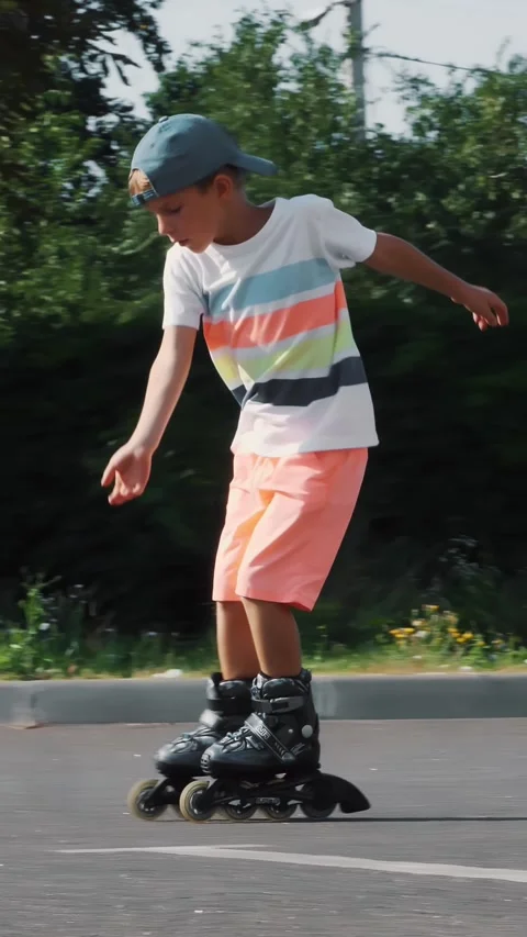 Happy boy of seven, rollerblading, a hot summer day. Slow motion Stock Footage 311318225