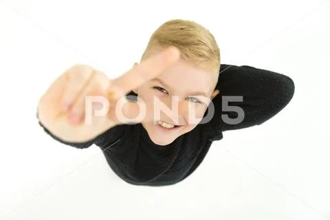 The happy boy show two finger to the camera. View from above Stock Photos