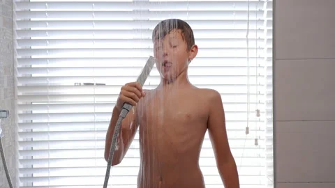 Happy boy singing and dancing while having a shower in the bathroom. Stock Footage 150950330