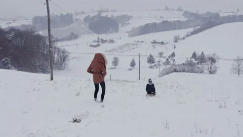 Happy boy sledding down white hill in winter  Stock Footage 147855937