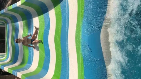 Happy boy is sliding down the water slide at aqua park. Stock Footage 160858852
