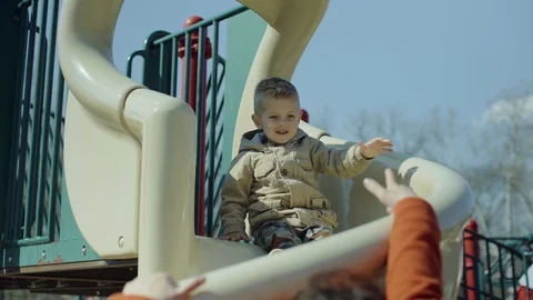 Happy boy sliding upside down in playground. 4k Stock-Footage 87487274