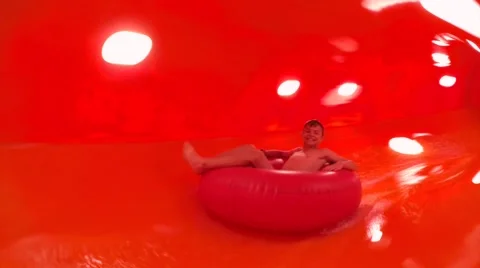 Happy boy smiling sliding down in aquapark Stock Footage 65844070