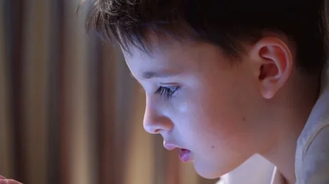 Happy Boy On Sofa Playing With Digital Tablet Video stock 58887837