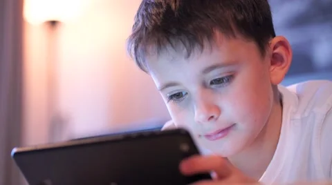 Happy Boy On Sofa Playing With Digital Tablet in Slow Motion Stock Footage 58887884