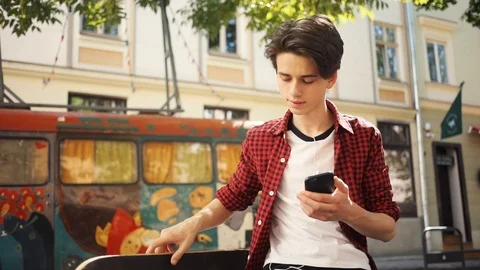 Happy boy using a mobile phone sitting smile guy business fashion hand child man Stock Footage 92050025