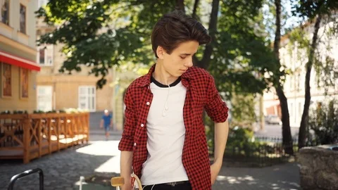 Happy boy using a mobile phone walk keeps skate guy business fashion hand child Stock Footage 92050595