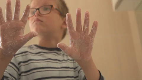 Happy boy washes his hands with soap and brushes his teeth in bathroom. Child Stock Footage 93534257