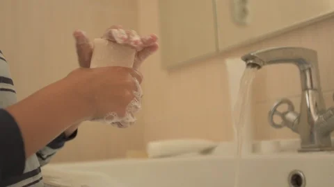 Happy boy washes his hands with soap and brushes his teeth in bathroom. Child Stock Footage 93534283