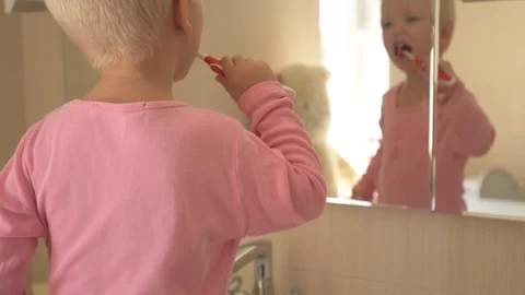 Happy boy washes his hands with soap and brushes his teeth in bathroom. Child Stock Footage 93534573