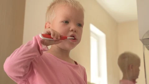 Happy boy washes his hands with soap and brushes his teeth in bathroom. Child Stock Footage 93534589
