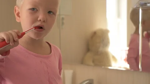 Happy boy washes his hands with soap and brushes his teeth in bathroom. Child Stock Footage 93534591