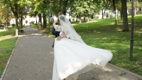 Happy bride and groom dancing on a street Stock Footage 85594907