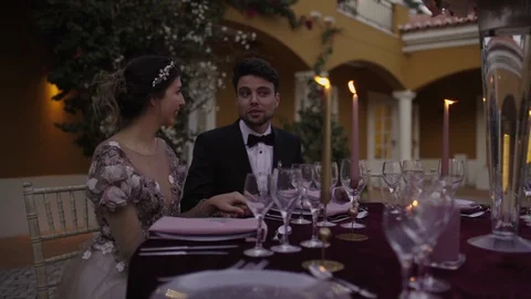Happy bride and groom talking at a wedding table Stock Footage 87145448