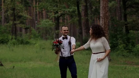 Happy bride being led by the hand of a charming suitor. Stock Footage 69886692