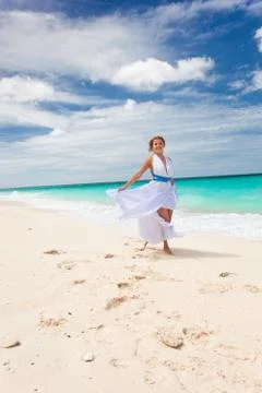 Happy bride dancing on beach Stock Photos
