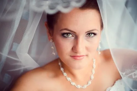 Happy bride looking in window Stock Photos