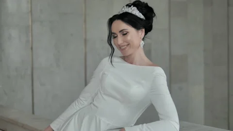 Happy bride posing touching her neck. Lady in white dress posing. Stock Footage 151774551