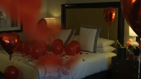 Happy bride sitting in bed with balloons Stock Footage 115924954