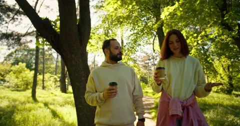 A happy brunette guy with a beard and his brunette girlfriend in a yellow hoodie Stock Footage 280616139