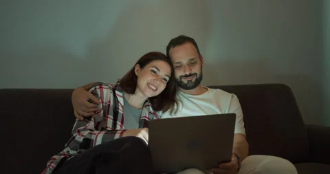 A happy brunette guy with a beard in a white T-shirt hugs his girlfriend in a Stock Footage 280652134