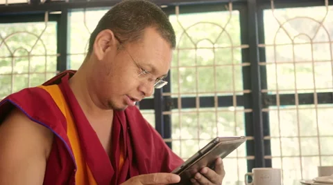 Happy Buddhist Monk with tablet Stock Footage 60206581