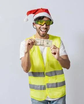 Happy builder engineer with christmas hat holding one dollar bill isolated... Stock Photos