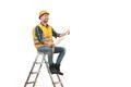 The happy builder with a paper sitting on the ladder on the white background Photo