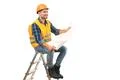 The happy builder with a paper sitting on the ladder on the white background Photo