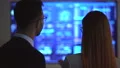 The happy business couple discussing near the display 4k or 4k+ Resolution