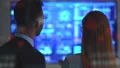 The happy business couple discussing near the display on the hologram background 4k or 4k+ Resolution