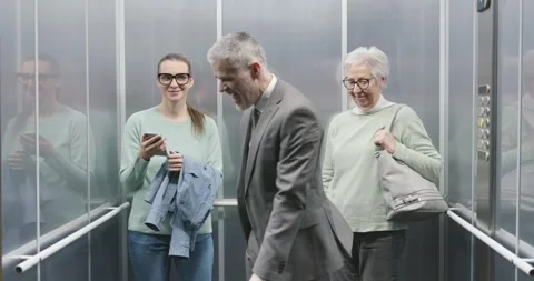 Happy business executive celebrating in the elevator Stock Footage 306149792
