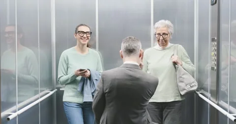 Happy business executive celebrating in the elevator Stock Footage 306149801