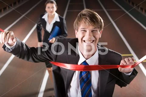 Happy business man is winning a business race Stock Photos