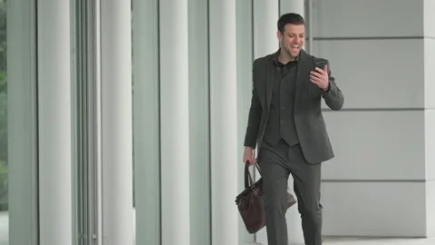 Happy business people looking at mobile phone Stock Footage